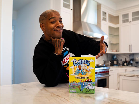 Kid Cudi posing with Limited-Edition Bisquick Funnel Cake Mix